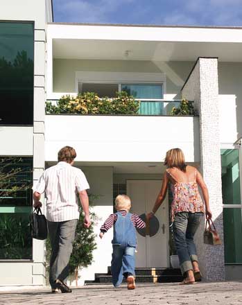 Parents with their son at the home entrance